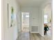 Bright hallway featuring modern flooring and fresh white walls leading to the bathroom at 808 E Hanover Rd, Graham, NC 27253