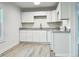 Modern kitchen with white cabinets and stainless steel appliances at 808 E Hanover Rd, Graham, NC 27253
