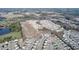 Aerial view of a residential neighborhood featuring new homes, roadways, and nearby pond at 817 Kenyon Springs Dr, Zebulon, NC 27597