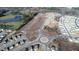 Bird's-eye view showcasing new residential home construction within a community and pond at 817 Kenyon Springs Dr, Zebulon, NC 27597