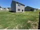 Expansive backyard with healthy green grass, perfect for outdoor activities and relaxation at 817 Kenyon Springs Dr, Zebulon, NC 27597