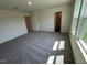 Bright bedroom with large windows offering plenty of natural light and a comfortable carpeted floor at 817 Kenyon Springs Dr, Zebulon, NC 27597