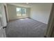 Sunlit room features a soft, neutral carpet and large windows providing great natural light at 817 Kenyon Springs Dr, Zebulon, NC 27597