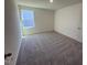 Spacious bedroom featuring plush carpeting, a large window, and ample natural light at 817 Kenyon Springs Dr, Zebulon, NC 27597
