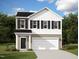 Two-story home featuring black shutters and a two-car garage, showcasing classic architectural design at 817 Kenyon Springs Dr, Zebulon, NC 27597