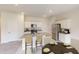 Well-lit kitchen with an island featuring granite countertops, stainless steel appliances, and modern fixtures at 817 Kenyon Springs Dr, Zebulon, NC 27597