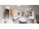 Wide-angle view of the living room with an open-concept kitchen featuring stainless steel appliances at 817 Kenyon Springs Dr, Zebulon, NC 27597
