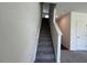 Carpeted staircase leading to the second level, offering a smooth transition between floors at 817 Kenyon Springs Dr, Zebulon, NC 27597