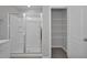 Bathroom with glass shower and view to closet with shelves at 82 White Ash Dr, Clayton, NC 27527