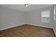 Minimalist bedroom with laminate flooring and a single window at 82 White Ash Dr, Clayton, NC 27527