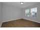 Neutral bedroom with wood flooring and two windows offering neighborhood views at 82 White Ash Dr, Clayton, NC 27527