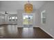 Dining room with a modern light fixture, large windows, and a sliding glass door at 82 White Ash Dr, Clayton, NC 27527
