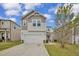 Charming two-story home with a two car garage, neutral siding, and well-manicured lawn at 82 White Ash Dr, Clayton, NC 27527