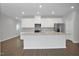 Modern kitchen with white cabinets, stainless steel appliances, granite countertops and a large island at 82 White Ash Dr, Clayton, NC 27527