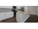 Bright kitchen with white cabinets, stainless steel appliances, and an island with a granite countertop at 82 White Ash Dr, Clayton, NC 27527