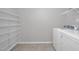 Laundry room with storage shelves and a white washer and dryer at 82 White Ash Dr, Clayton, NC 27527