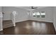 A carpeted staircase and a ceiling fan enhance this light filled living room at 82 White Ash Dr, Clayton, NC 27527