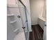 Modern bathroom featuring a glass-enclosed shower and a sleek vanity with dark vinyl plank flooring at 821 Kenyon Spring Dr, Zebulon, NC 27597