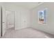 Bedroom features a closet, neutral carpet, and bright lighting at 821 Kenyon Spring Dr, Zebulon, NC 27597