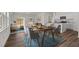 Bright dining area featuring a wooden table set for four, flowing to living and kitchen at 821 Kenyon Spring Dr, Zebulon, NC 27597