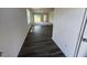 Hallway with a view of the carpeted living room, windows, and sliding glass door at 821 Kenyon Spring Dr, Zebulon, NC 27597