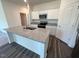 Modern kitchen featuring granite counters, a central island, and stainless steel appliances at 821 Kenyon Spring Dr, Zebulon, NC 27597