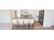 Modern kitchen featuring a granite island with seating, stainless steel appliances, and white cabinetry at 821 Kenyon Spring Dr, Zebulon, NC 27597