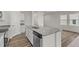 Kitchen island features stainless steel dishwasher, sink, faucet and granite countertops at 821 Kenyon Spring Dr, Zebulon, NC 27597