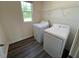 Laundry room with white washer and dryer and a window at 821 Kenyon Spring Dr, Zebulon, NC 27597