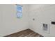 Bright laundry room with a window, wire rack for storage, and vinyl flooring at 821 Kenyon Spring Dr, Zebulon, NC 27597