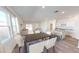 Open-concept living space with dining area, kitchen, and large windows providing ample light at 821 Kenyon Spring Dr, Zebulon, NC 27597