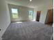 Spacious main bedroom with natural light, plush carpeting, and an en-suite bathroom access at 821 Kenyon Spring Dr, Zebulon, NC 27597
