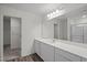 Bathroom with a long white vanity with a large mirror and a glass shower at 845 Kenyon Spring Dr, Zebulon, NC 27597