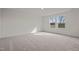 Sun-drenched bedroom with plush carpeting and windows offering a serene view at 845 Kenyon Spring Dr, Zebulon, NC 27597