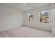 Bright, empty bedroom with natural light coming through two windows, and neutral carpet at 845 Kenyon Spring Dr, Zebulon, NC 27597