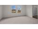 Bright bedroom with two windows and neutral carpet at 845 Kenyon Spring Dr, Zebulon, NC 27597