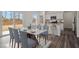 Elegant dining area with a white marble table and an open view to the kitchen at 845 Kenyon Spring Dr, Zebulon, NC 27597