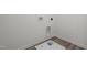 Functional laundry room with modern wood-look vinyl flooring at 845 Kenyon Spring Dr, Zebulon, NC 27597