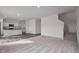 Open concept living room with a view of the modern kitchen featuring granite countertops at 845 Kenyon Spring Dr, Zebulon, NC 27597