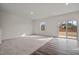 Bright living room with a large window and sliding glass door to the backyard at 845 Kenyon Spring Dr, Zebulon, NC 27597