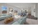 Bright living room with large window, hardwood floors, and an adjacent dining and kitchen area at 845 Kenyon Spring Dr, Zebulon, NC 27597
