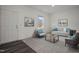 Cozy living room featuring modern furniture, a large window, and dark wood-look flooring at 845 Kenyon Spring Dr, Zebulon, NC 27597
