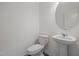 A stylish half-bathroom featuring a sleek pedestal sink and contemporary fixtures at 845 Kenyon Spring Dr, Zebulon, NC 27597