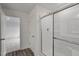 Bathroom shower with sliding glass doors, and a view of a bedroom in the background at 845 Kenyon Spring Dr, Zebulon, NC 27597
