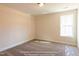 Neutral bedroom with plush carpet and a window letting in natural light at 85 Purslane Dr, Franklinton, NC 27525