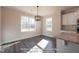 Cozy dining area adjacent to kitchen has a modern light and sun-filled windows at 85 Purslane Dr, Franklinton, NC 27525