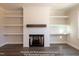 Elegant fireplace with white surround, wooden mantle, and built-in shelves create a cozy focal point at 85 Purslane Dr, Franklinton, NC 27525
