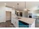 Open kitchen featuring large island with stone countertops and stainless steel appliances at 85 Purslane Dr, Franklinton, NC 27525