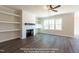 Bright living room with built-in shelves, fireplace, and modern ceiling fan for ultimate comfort at 85 Purslane Dr, Franklinton, NC 27525