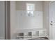 Bright mudroom features white wainscoting, coat hooks, storage, and a window at 85 Purslane Dr, Franklinton, NC 27525